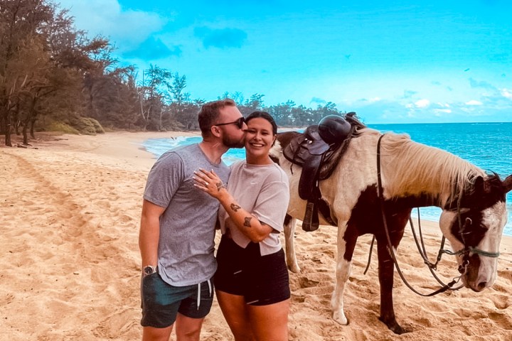 a man standing next to a horse