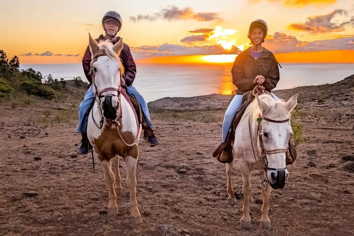 a group of people riding on the back of a horse