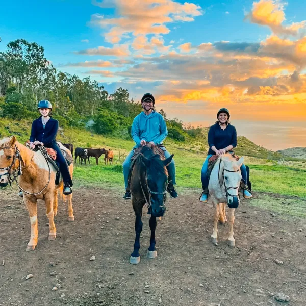 a group of people walking down a dirt road