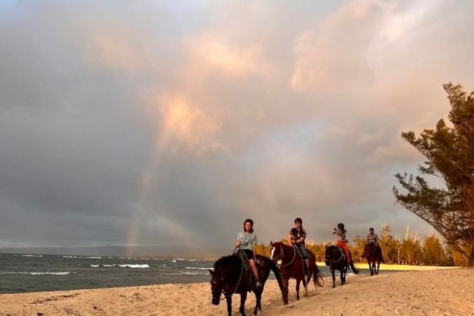 a group of people riding on the back of a horse